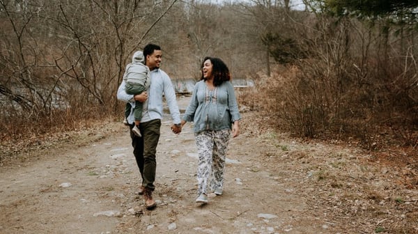 Mother, father and young child walking down the road