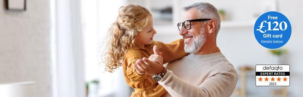 Grandad and granddaughter dancing and smiling. Over 50s life insurance gift card offer
