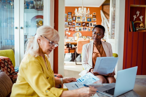 Two women looking at papers